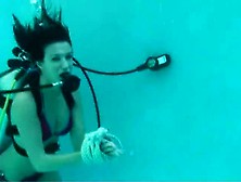 Scuba Girl Tied To Pool Ladder