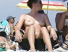 Big Breasted Coquette Sunbathing On A Nudist Beach