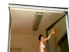Short Haired Girl Washes Windows Topless