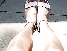 Rubbing Shiny Pantyhose Legs Outdoors