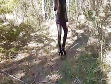 Walking On The Wood Wearing A African Dress,  Pantyhose And High Heels Ankle Boots