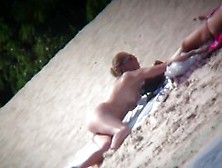 Nude Blonde Babe Sunbathing At The Beach And Caught On Cam