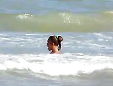 Topless Legal Age Teenager Playing At Beach In Water