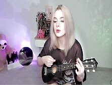 Hot Blonde Girl Playing On Ukulele And Singing In Naughty Outfit