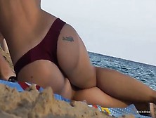 Nice Big Implants On This Girl Relaxing In The Sand