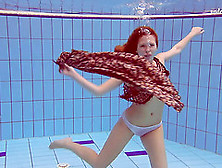 Slim Redhead Looker Dives Around The Pool In The Nude