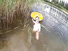 Having Fun With A Water Donut Nude Into The Lake