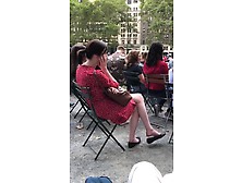 Brunette In A Sexy Summer Dress Dangles Her Flat Shoe In Public