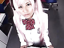Cute Japanese Babe Sits Down And Displays Her Sexy Body Wearing Her Pink Wig And White And Black School Uniform.