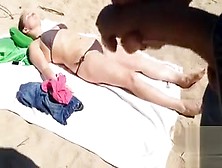 Jerking Off As A Bikini Woman Lies On The Beach