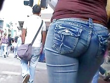 Hot Body Girl In Tight Jeans Walking The Street With A Voyeur Behind Her