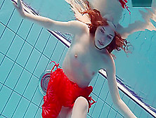 Red Dressed Teen Swimming With Her Eyes Opened