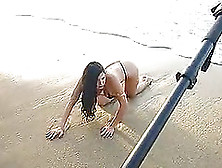 Sexy Brunette Wearing Thong Poses For The Camera On A Sandy Beach
