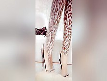 Woman In Sexy Leopard Outfit And High Heels Trampling Her Male Slave