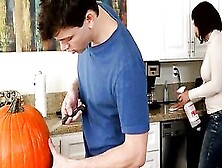 Alex D.  Carves A Hole In A Pumpkin For Halloween While His Mother Cleans The Kitchen.  He Leaves The Guts