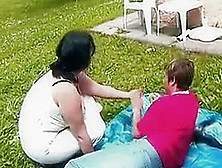 Chubby Brunette Mom Outdoors By Young Guy