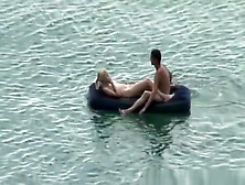 Group Of Nudist In Air Mattress In The Water