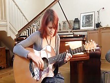 Redhead Playing Guitar Down Blouse And Cleavage