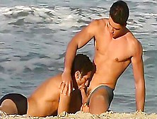Two Relaxed Man Are Having Oral Sex On The Beach