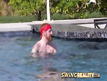 Ginger Swinger Couple Enjoys Some Naughty Teasing In The Pool With The Other Members Of The House.