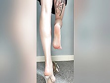 Doll In A Sexy Black Dress Teasing With Her Tattooed Legs And Feet