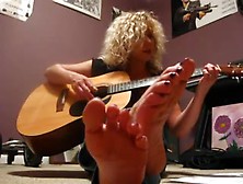 Toes Up Close While She Sings And Plays Guitar
