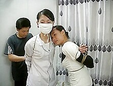 Two Chinese Girls Tied,  One Wearing Cloth Mask