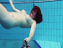 Redheaded Katrin Is Stripping Underwater