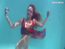 Young Redhead Swims In A Pretty Dress