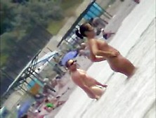 Voyeur View Of Fun In The Water On A Nudist Beach