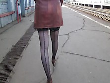Girl In Seamed Stockings Walking On A Train Station