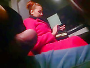 Young Woman In A Red Coat On A Bus