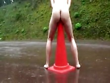Girl Sitting On Signaling Cone On The Road