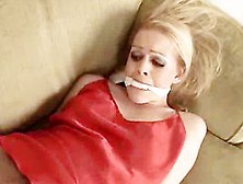 Blonde Cutie Ashley Roberts Struggles Against Her Bondage On The Sofa
