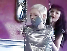 Blonde Girl Completely Tape Mummified To Swing