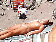 Spy Cam Shot Of A Hot Nudist Babe Tanning On The Beach