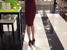 Sophisticated Brunette Wearing Glamorous Red Dress And High Heels In Public