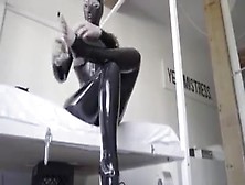 Hooded Rubber Woman In Latex Catsuit And Ballet Boots